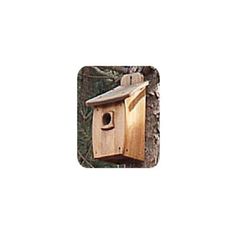 a wooden birdhouse hanging from the side of a tree