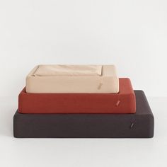 three different colored sheets sitting on top of each other