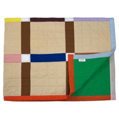 a multicolored patchwork quilt on a white background