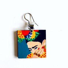 100% Hand Painted Frida Earrings, and made from scratch. Every single element such as metal jump rings, wood and hook earring findings was assembled by hand. Original Artwork. No Prints. This gorgeous hand painted Frida earrings are a beautiful mini masterpiece. Original Artwork. We created them using high quality acrylic paint which had been protected with a special gloss coat to ensure its durability.Very light to wear and one of a kind accessory. It's the perfect gift for that very special pe Enamel Pendant Earrings For Gifts, Hand Painted Resin Earrings In Artsy Style, Hand Painted Artsy Resin Jewelry, Quirky Multicolor Dangle Jewelry, Artsy Hand Painted Resin Jewelry, Artsy Hand Painted Dangle Earrings, Artistic Resin Earrings With Ear Wire, Artistic Enamel Dangle Earrings, Hand Painted Enamel Earrings For Gifts