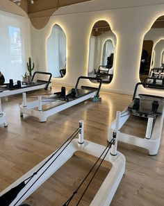 an empty gym with mirrors and treadmills