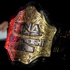 a close up of a wrestling belt on a black background with the words, i am enough to weigh champion