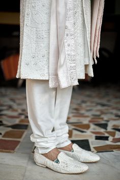 Ivory woven sherwani with mandarin collar, all over mixed pattern, sequin and tonal thread embroidery. Paired with cotton silk kurta, churidar and stole with embroidered border.
Components: 4
Pattern: Embroidered and Woven
Type Of Work: Thread and Sequin Work
Neckline: Mandarin Collar
Sleeve Type: Full Sleeves
Fabric: Cotton Silk, Lining: Viscose Poly
Color: Ivory
Other Details: 
Front and side slits
Attached lining
Sherwani Closure: Front concealed placket
Note: The safa, kalangi and mala worn Traditional Off-white Kurta With Naqshi, Traditional Off White Kurta With Naqshi, Off White Naqshi Bandhgala, White Dabka Sherwani Traditional Fit, White Traditional Sherwani, White Transitional Sherwani With Traditional Fit, Transitional White Sherwani With Traditional Fit, Designer White Raw Silk Bandhgala, White Raw Silk Bandhgala For Designer Wear