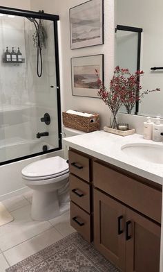 a bathroom with a sink, toilet and shower