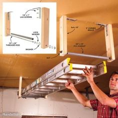 a man is working on the underside of a metal ladder that has been attached to an overhead garage door