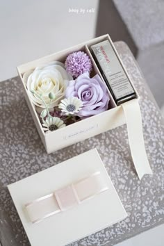 an open box with some flowers in it