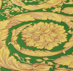 an ornate green and gold wallpaper with swirls on it's edges is shown