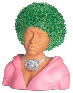 a figurine of a woman with green hair and jewelry on her neck, wearing a pink dress