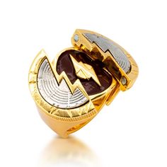 a gold and silver ring with a lightning symbol on the front, set against a white background