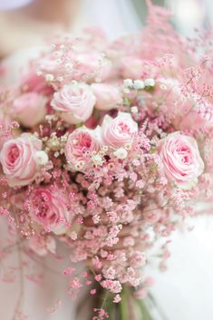 a bouquet of pink roses and baby's breath is shown in this close up photo