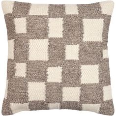 a brown and white pillow with squares on it