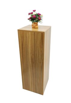 a vase with flowers sitting on top of a wooden box