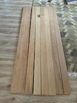 wood planks laying on the floor next to a bed