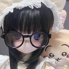 a close up of a doll wearing glasses