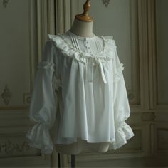 For a beautiful and elegant young lady. The blouse is richly decorated with frills and lace embroidery around her shoulders. Her sleeves have a relatively loose silhouette, and her chest is decorated with a ribbon. Her graceful beauty overflows. Bring romance to your everyday life. 
 
 

 

 
 
 Size 
 
 S size 
 
 Neck circumference: 40cm or less 
 Shoulder width: 38cm or less 
 Bust: 98cm or less 
 
 M size 
 
 Neck circumference: 45cm or less 
 Shoulder width: 42cm or less 
 Bust: 118cm or le Elegant White Tops With Ruffle Hem, Elegant White Top With Ruffle Hem, Elegant Blouse With Ruffled Collar And Ruffle Hem, Elegant Blouse With Ruffles And Ruffled Collar, Feminine Formal Blouse With Lace Patchwork, Feminine Lace Patchwork Blouse For Formal Occasions, Elegant White Ruffled Tops, Feminine White Blouse With Ruffles, White Puff Sleeve Blouse With Ruffles