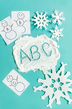 paper snowflakes and cutouts with the word abcq on them are shown