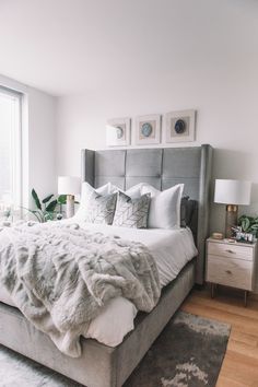 a bedroom with a large bed covered in blankets and pillows