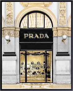 a prada store front with an arched window and gold trim on the outside wall