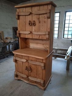 a large wooden cabinet sitting inside of a room