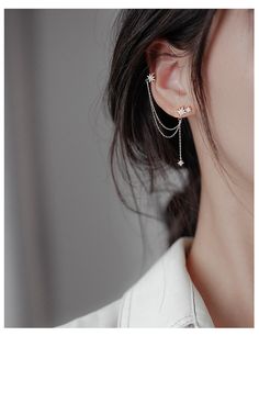 a close up of a person wearing some kind of ear chain