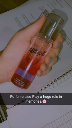 a woman holding a bottle of perfume in her hand with the caption, perfume also play a huge role in memories