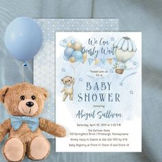 a baby shower with a teddy bear and balloons