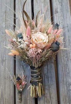 a vase filled with flowers sitting on top of a wooden table