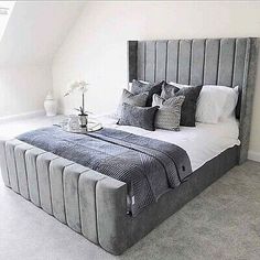 a large bed sitting in the middle of a bedroom