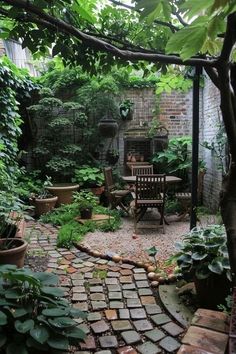 an outdoor patio with chairs and tables surrounded by greenery