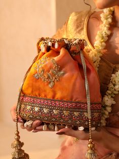 About This Item Introducing THE TAN CLAN Embroidered Embellished Potli Bag--a premium accessory designed to elevate your style for any special occasion. This luxurious drawstring purse is the perfect addition to your collection, ideal for weddings, festive celebrations, Diwali, New year, Christmas, bridesmaid, anniversary, engagements, baby shower and other significant events. Description: THE TAN CLAN Embellished Potli Clutch | Premium Women Pouch | Elegant Wedding Purse for Girls | Luxurious Drawstring Purse for Special Occasions *Material: Crafted from high-quality fabric, this potli clutch boasts a rich, opulent texture that complements its exquisite design. The premium materials ensure both durability and a luxurious feel. *Design: Adorned with intricate embellishments that shimmer an Diwali New Year, Potli Purse, Pouch Drawstring, Potli Bag, Drawstring Purse, Potli Bags, Wedding Purse, Embroidery Bags, Diwali Gifts