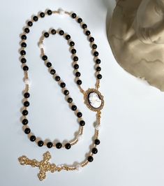 This Luxurious Rosary is uniquely designed and hand-made exclusively at Reminiscent Rosaries & Designs.  Each piece is made with only the highest-quality domestic/imported materials and made to last.  --- Full length of Rosary measures approximately 20.5". --- 8mm Obsidian and Pearl beads --- Anti Tarnish / Tarnish Resistant --- Perfect for any special occasion or Religious event --- Ready to ship in 1-2 business days Your experience matters most to us at Reminiscent Rosaries.  Please reach out if you have any questions or concerns. Follow our journey and get firsthand insight into the latest designs! IG: @reminiscentrosaries Elegant Beaded Rosary For Jewelry Making, Elegant Rosary With Round Beads For Healing, Elegant Healing Rosary With Round Beads, Elegant Healing Rosary, Elegant Beaded Rosary As Gift, Elegant Beaded Rosary For Gift, Elegant Beaded Rosary With Round Beads, Elegant Beaded Rosary, Elegant Adjustable Rosary With Polished Beads