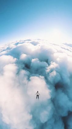 the sky is filled with clouds and there is a person in the middle of it