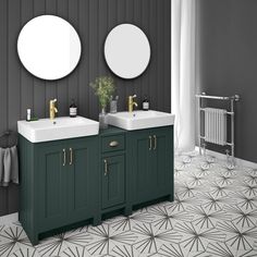 a bathroom with two sinks and mirrors on the wall next to a radiator