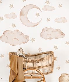 a baby's crib in front of a wall with stars and moon decals