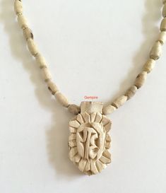 "Tulsi Mala Necklace with Tulsi Radhe Pendant (Radhe Handcarved in Sanskrit). This beaded necklace can be worn by men as well as women. Tulsi beads are made from Tulsi (Holy Basil) plant wood, considered as most sacred in India. Tulsi plant is worshipped in India and the food offered to Indian Gods is incomplete without the offereing of Tulsi leaves along with it. Tulsi Mala provides protection to the wearer and is said to maintain Health, provide Peace of Mind and reduce Stress. They are used t Handmade Traditional Mala For Festivals, Traditional Handmade Mala For Festivals, Traditional 108 Beads Jewelry Gift, Carved Necklaces For Festivals And Gifts, Traditional Wooden Beads Necklace For Meditation, Carved Jewelry For Festivals And Gifts, Carved Jewelry As Festival Gift, White Spiritual Jewelry For Festival, Spiritual Necklaces For Festivals