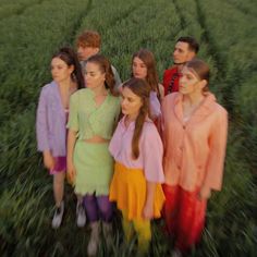 a group of people standing next to each other in a field