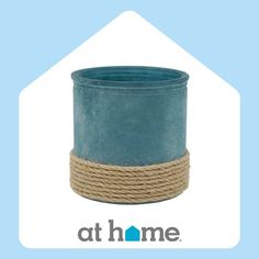 a blue pot sitting on top of a rope