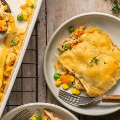 a white plate topped with food next to a casserole dish filled with chicken and veggies