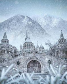 an old building with snow falling on it