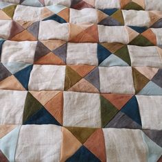 a patchwork quilt with various colors and shapes