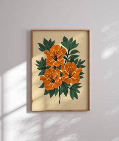 an orange and green floral print hangs on the wall