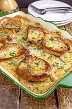 a casserole dish filled with meat and cheese on top of a wooden table