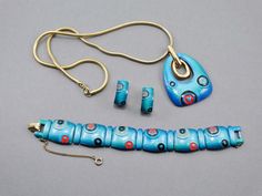 "This beautiful Eisenberg necklace, link bracelet, and clip earrings enamel set is from the early 1970's Eisenberg Artist Series, inspired by famous surrealist artists like Chagall, Pucci and Picasso. Finely enameled, an advertisement from 1973 boasted that these pieces are fired 27 times. Paper hang tags stated 'hand painted, 18k gold electroplated'. All pieces except for the bracelet signed Eisenberg. The bracelet has the E. Beautiful rich turquoise, teal, grey, red, and black - set in an 18k Retro Collectible Enamel Jewelry, Mid-century Gold Enamel Jewelry, 1970s Necklace, Surrealist Artists, Juliana Jewelry, Pucci Vintage, Vintage Rhinestone Jewelry, Book Pieces, Purple Orchids