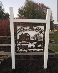 a metal sign that says green hill farm and has an image of a farm with animals on it