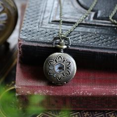 Small 25mm pocket watch necklace with a high quality quartz movement inside. On 28 inches of antiqued brass chain.  Available on a simple chain, or a chain that has 2 little Victorian birds attached.  Select which chain option you would like. I can make this chain any length for no extra charge.  Just leave me a note at checkout! You can adjust the time by pulling up the knob and turning.  Pressing the knob opens the watch.   Each watch comes with instructions for setting the time and changing t Antique Gold Quartz Pocket Watch As Gift, Antique Finish Pocket Watch As Gift, Brass Pocket Watch With Locket For Gift, Brass Locket Pocket Watch As Gift, Brass Pocket Watch With Locket As Gift, Antique Gold Medallion Pocket Watch Gift, Antique Brass Pocket Watch With Locket, Vintage Bronze Pocket Watch With Locket, Antique Gold Metal Pocket Watch With Antique Finish