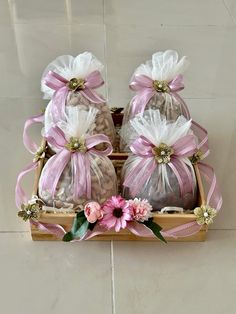 three small bags filled with candy and flowers