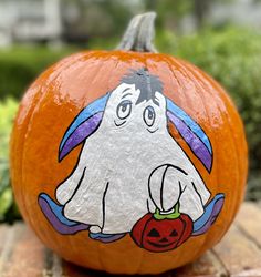 a painted pumpkin with a ghost on it