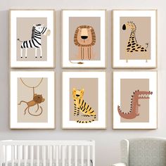 four framed pictures of animals are hanging on the wall in a baby's room