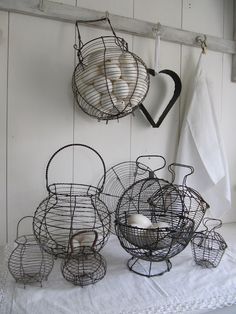 three bird cages are hanging on the wall