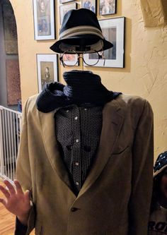 a mannequin dressed in a suit and hat